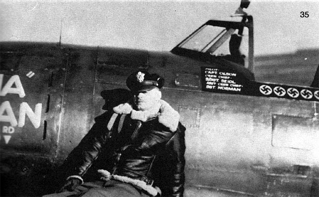 Captain Norman E Olson in uniform in front of plane photo