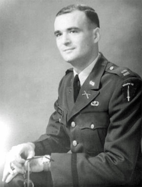 This portrait shows a U.S. Army officer with airborne and infantry credentials, photographed in a formal seated pose.